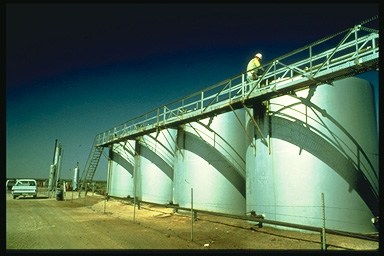 Picture of the storage fascility for oil which is sorrounded by large containment walls.